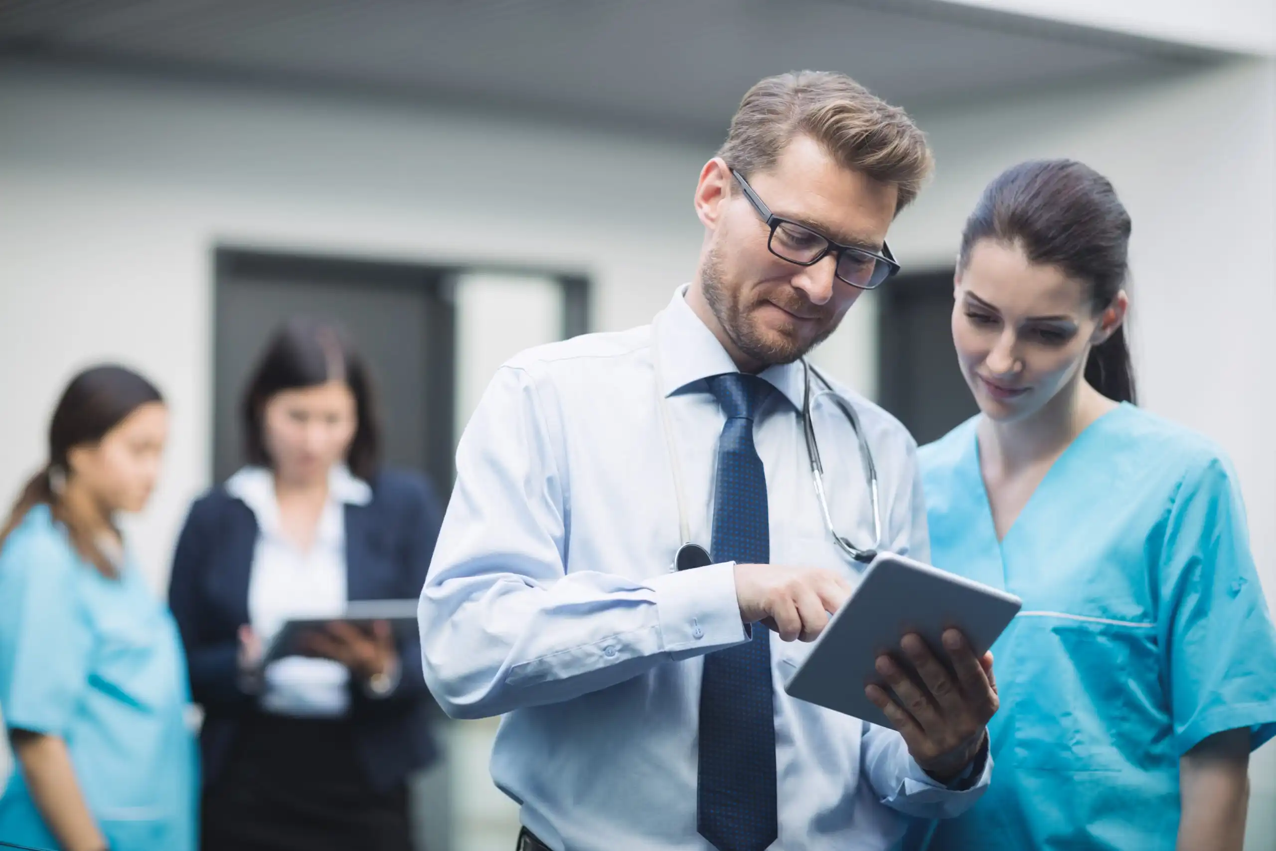 Healthcare colleagues reviewing a digital tablet together