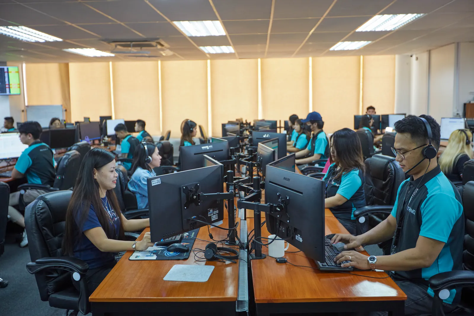 Colleagues working at computers in our Philippines office, supporting administrative coordination and documentation