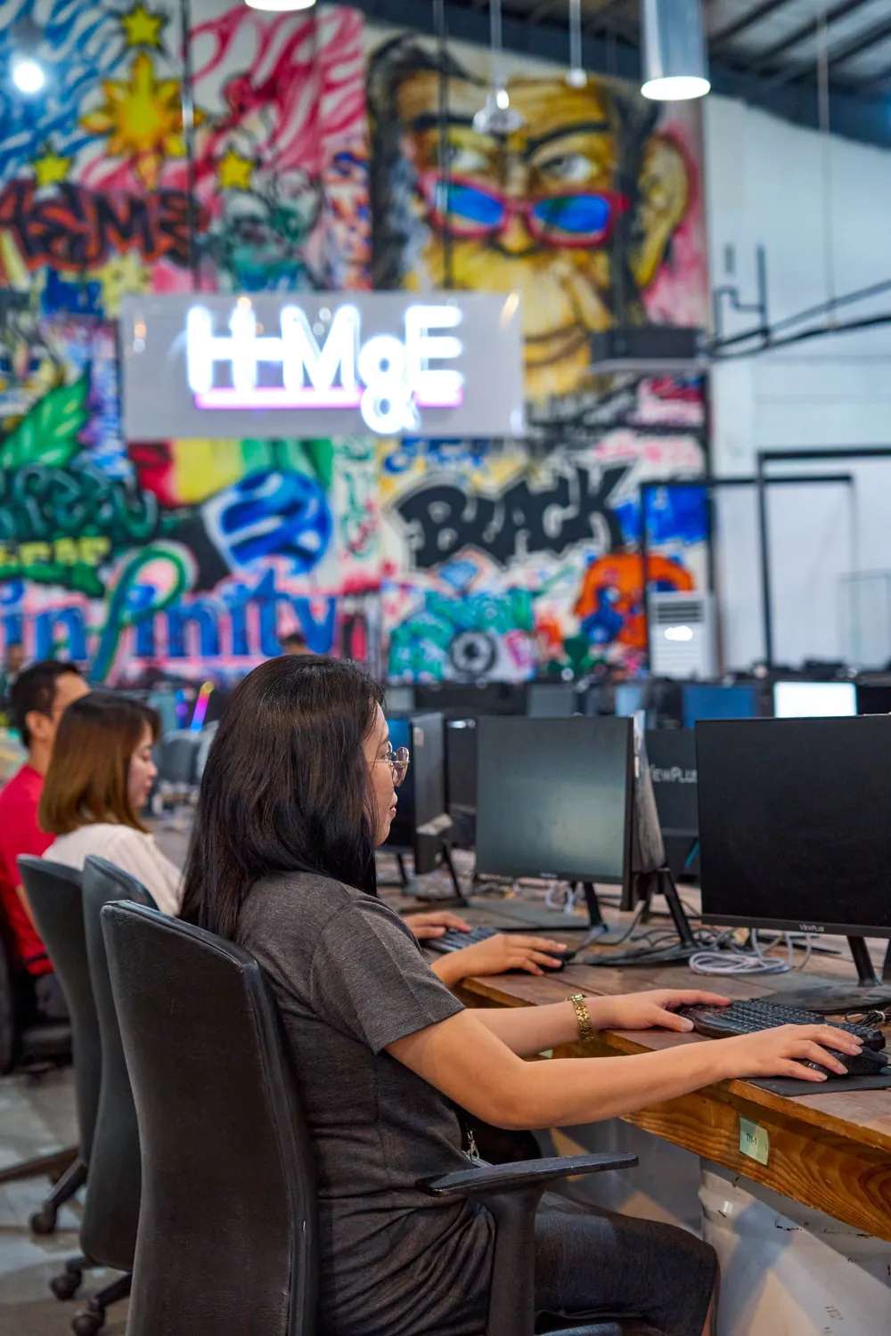 Team members working at computers in our Philippines outsourcing office