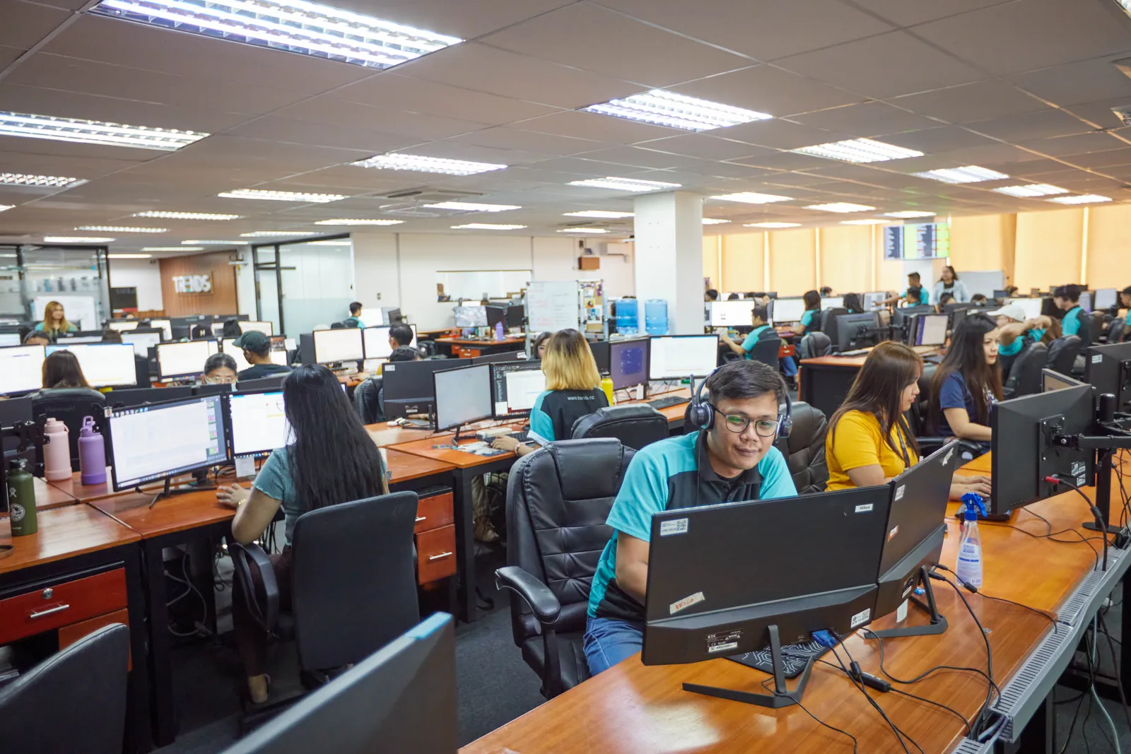 Computer workstations and team members in our Philippines office